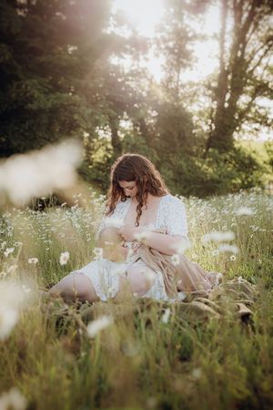 Dreamy sunset photo session in a wildflower meadow with soft golden light.
