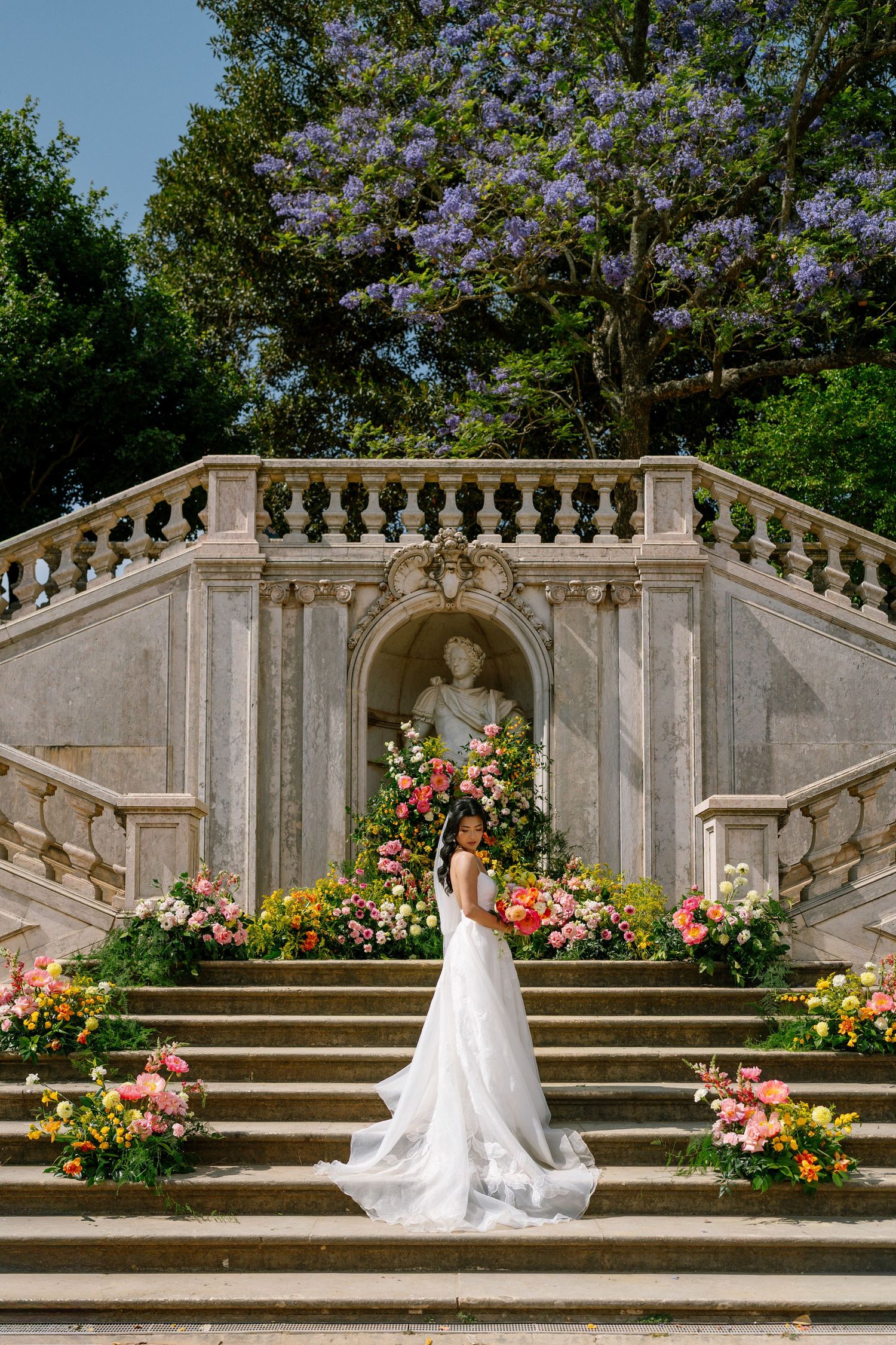 Elegant bride and groom kissing in the gardens of Fronteira palace in Lisbon on their wedding day