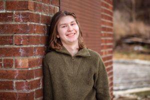 Person wearing olive green sweater leaning against red brick wall while smiling outdoors.
Janesville, WI
Brodhead, WI