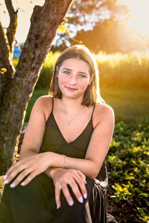 Outdoor portrait with golden sunlight filtering through trees in a natural garden setting.
Janesville, WI
Brodhead, WI