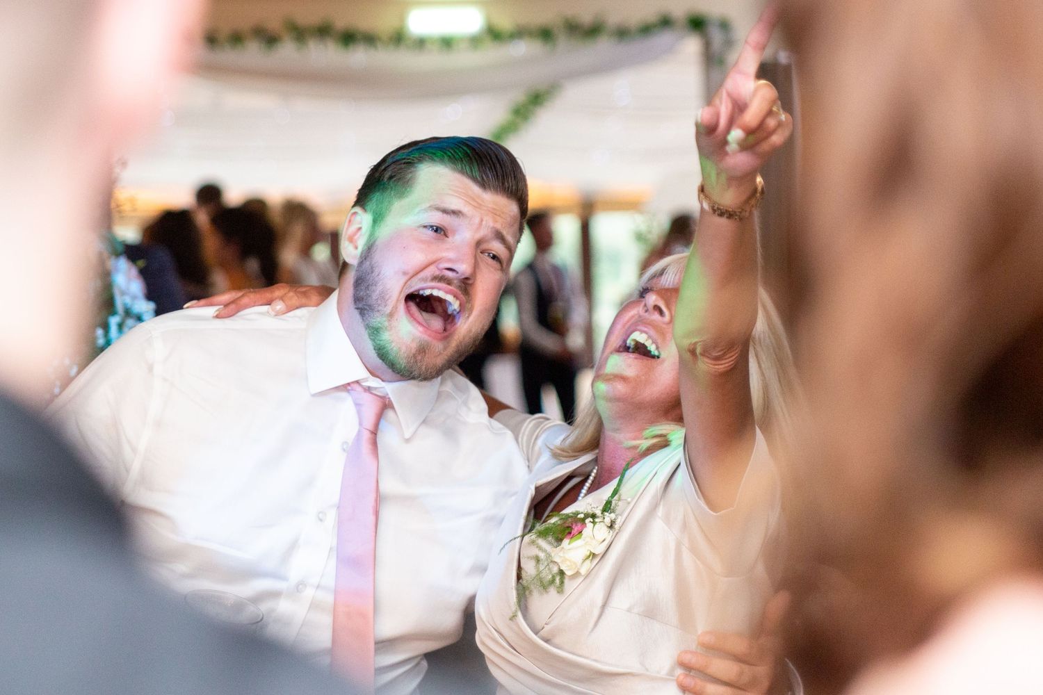 Candid celebration moment captured with festive lighting and laughter.