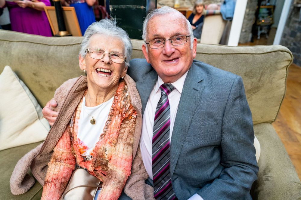 A joyful moment shared on a couch during a celebration.