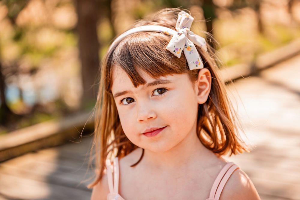 A series of outdoor portrait photos showing a person in natural sunlight with warm autumn tones.