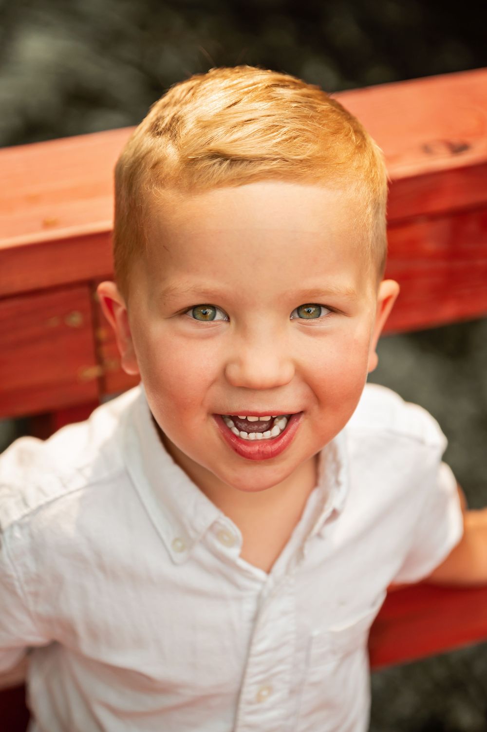 A sequence of joyful expressions in white shirt against a dark background.