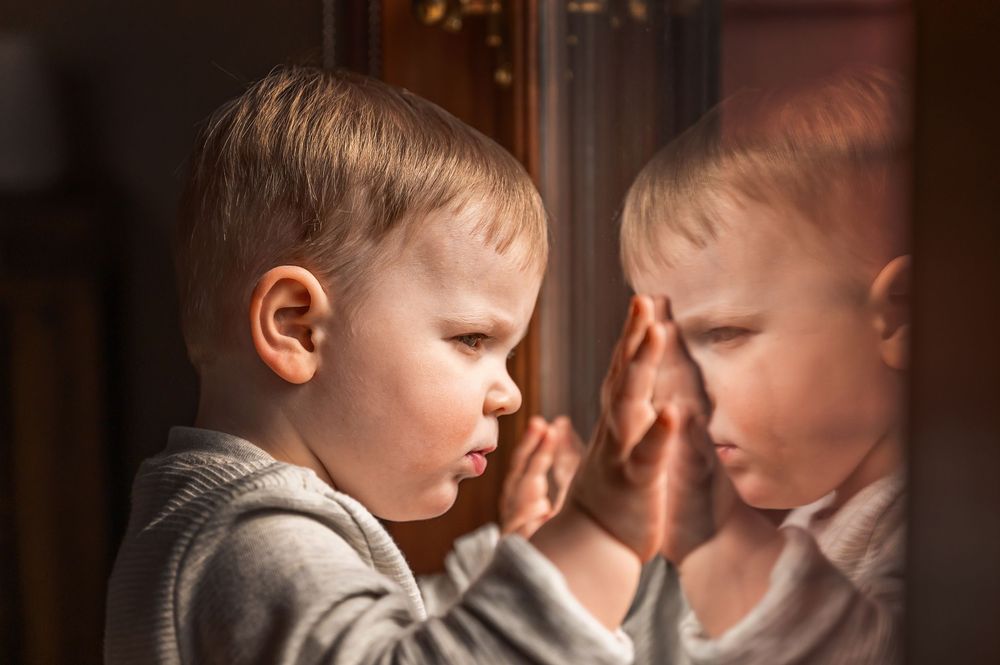 Seven connected images showing intimate parent-child moments in warm sunlit settings with soft shadows and tender expressions.