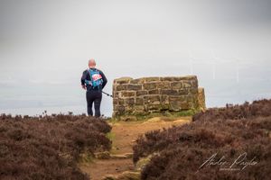 Ultra Runner passing the Alec Falconer Memorial seat