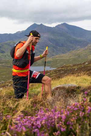 Ultra Runner climbing amongst the heather in Yr Wyddfa