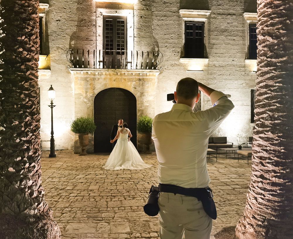 Wedding photographer Alan Harbord photographs wedding couple outside grand floodlit castle
