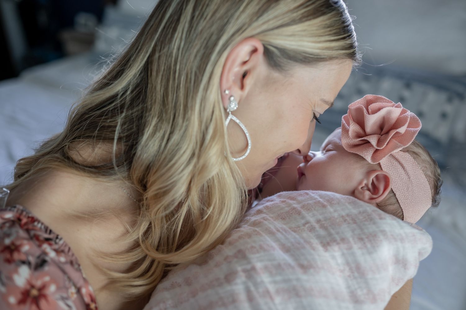 Mother and newborn baby snuggling in lifestyle newborn photoshoot in home session Palm Bay Melbourne Cocoa Beach Vero Florida Brevard County