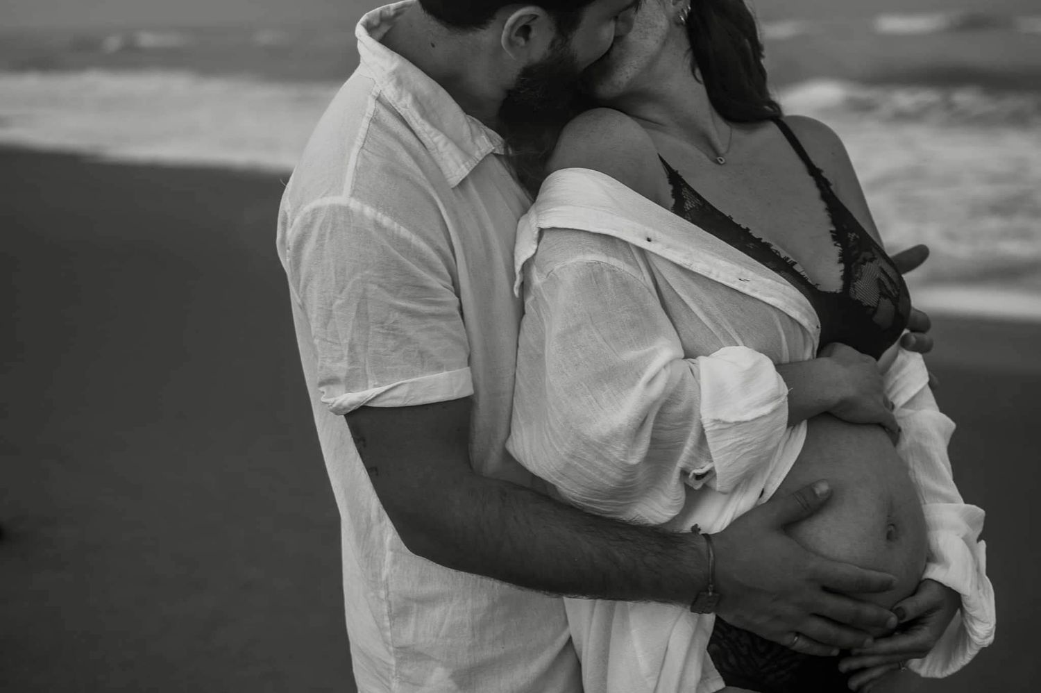 Couple maternity session photoshoot pregnant black and white on beach candid moment kiss Melbourne Cocoa Vero Florida Brevard County
