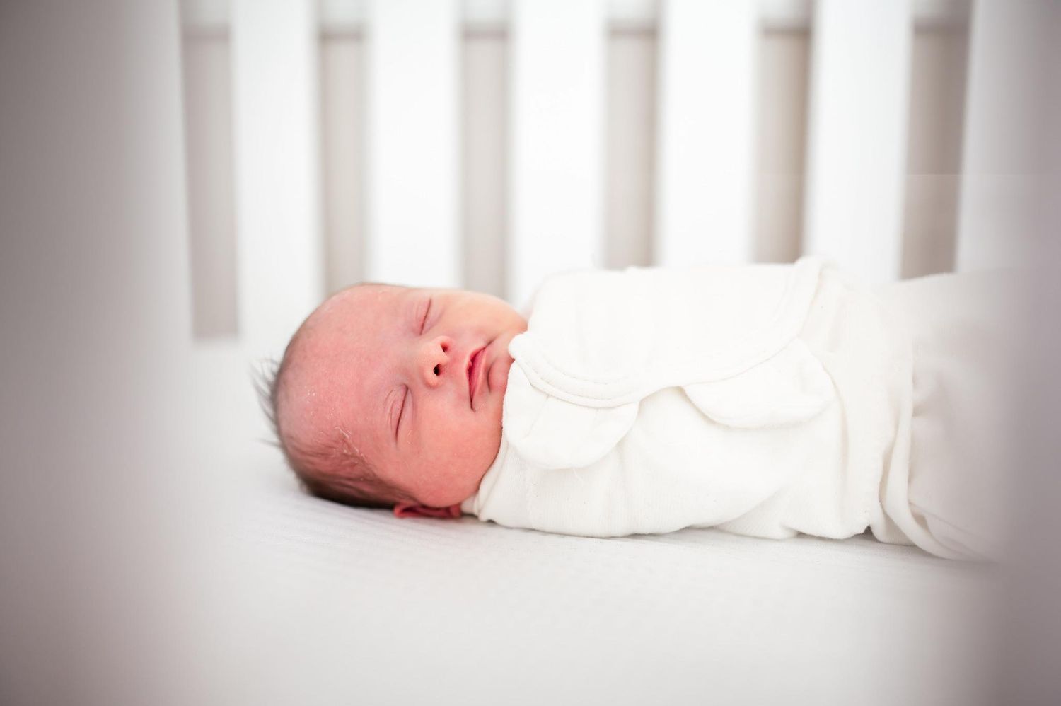 Newborn baby swaddled in crib lifestyle newborn session in home photoshoot Palm Bay Melbourne Vero Cocoa Beach Florida Bereaved County