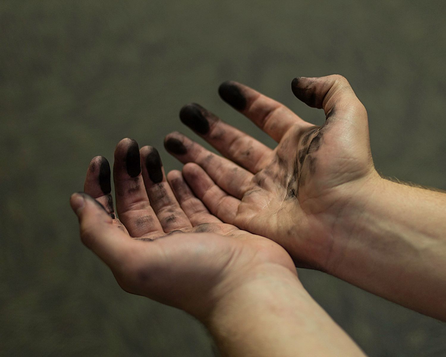 image of hands tinged with ink