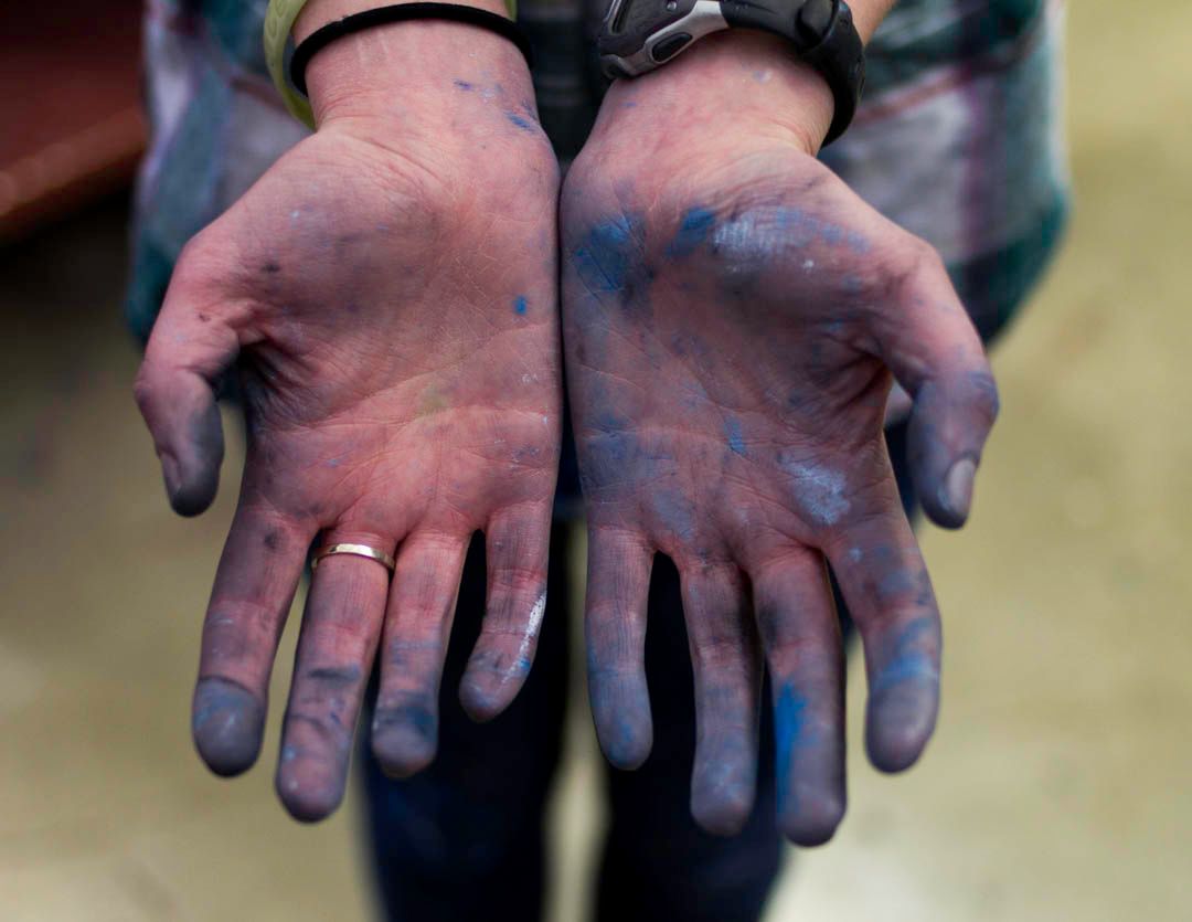hands with blue paint