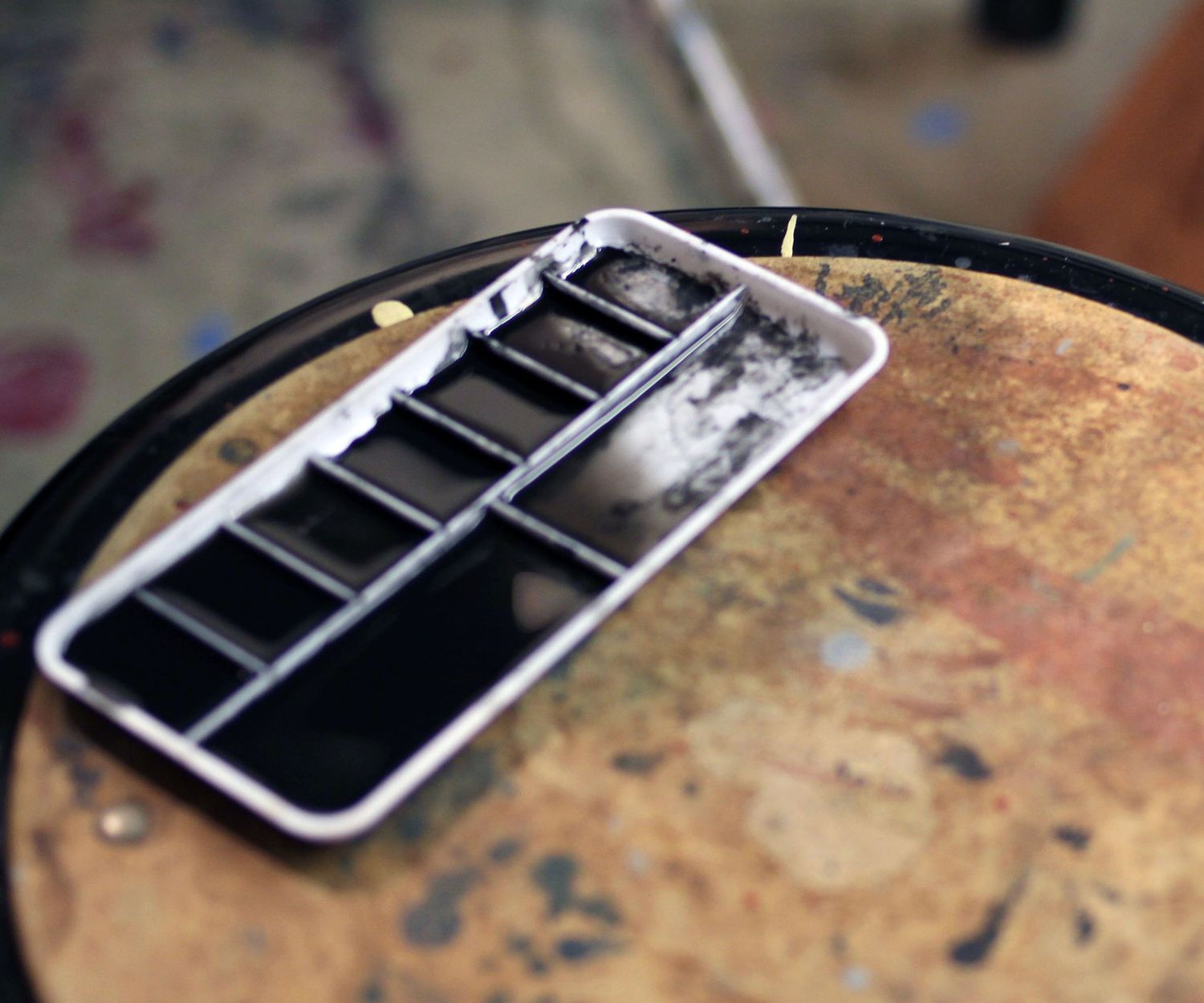 ink palette in studio, light bouncing off