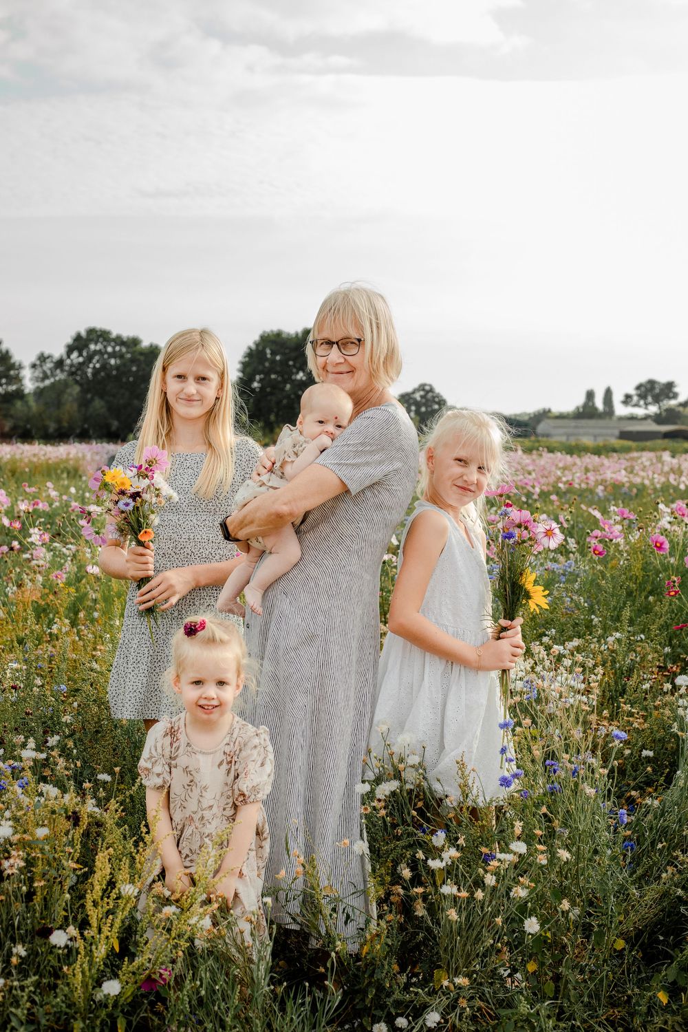 At Sam's Sunflowers on Hayling Island, Hampshire, a grandmother hugs her grandchildren amongst the wildflowers.