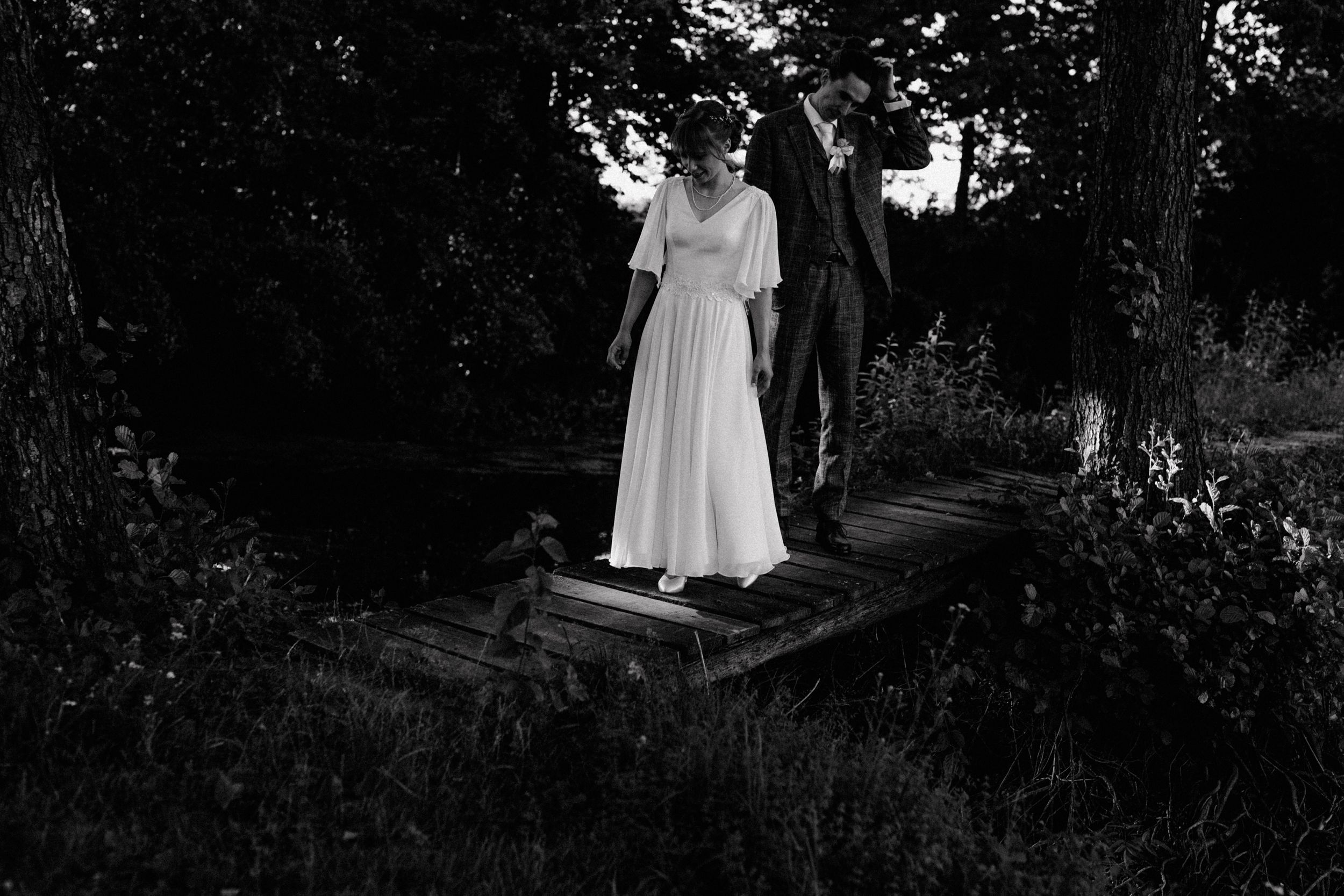 Crno bijela fotografija koja prikazuje zaigranost mladenaca prikazano kroz autentičnu vjenčanu fotografiju