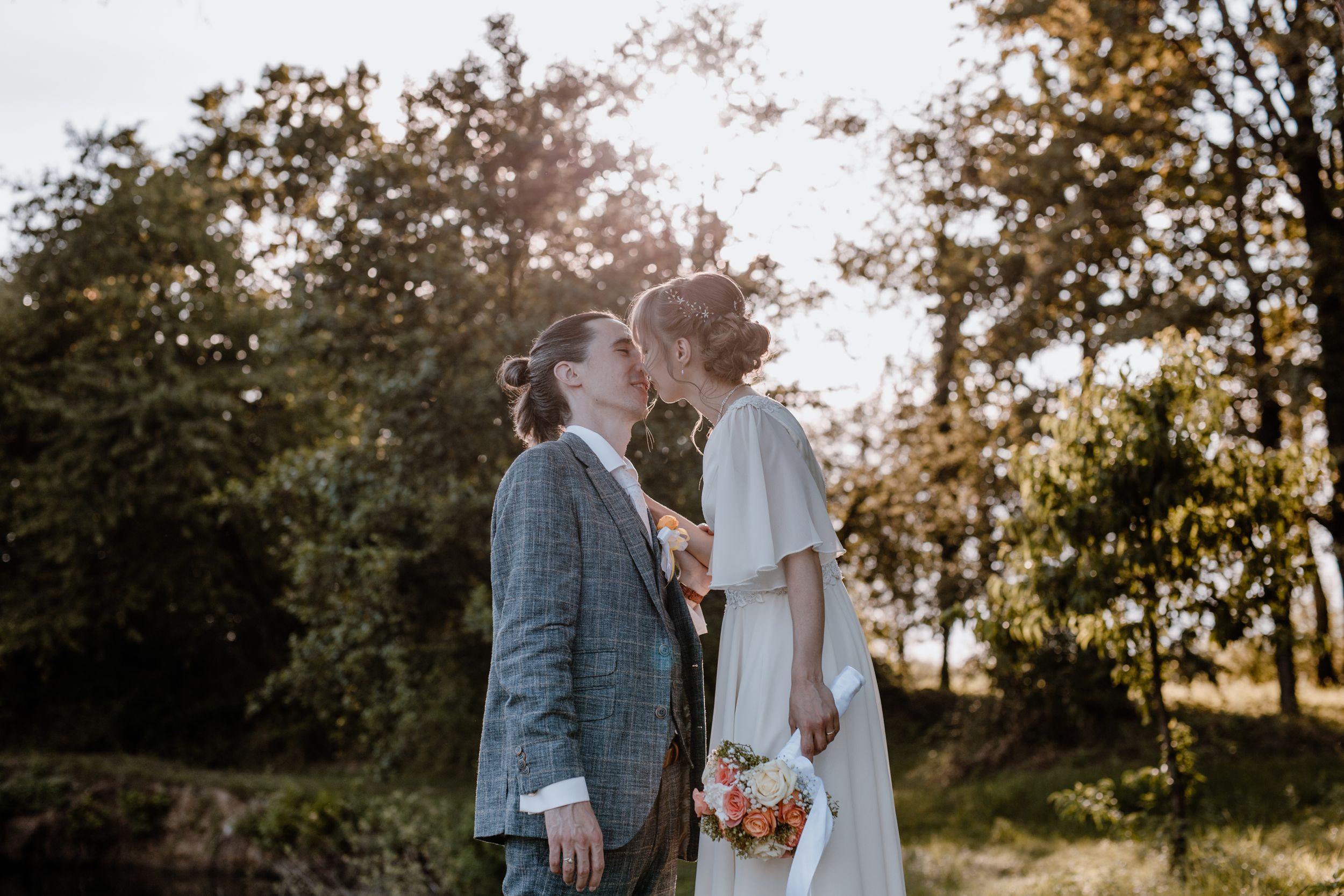 Kiss shared between bride and groom during their intimate wedding session.
