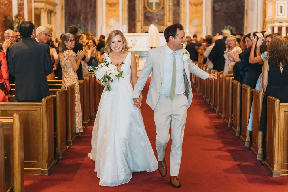 Bride and groom walking down the aisle at St. Matthew the Apostle Cathedral.