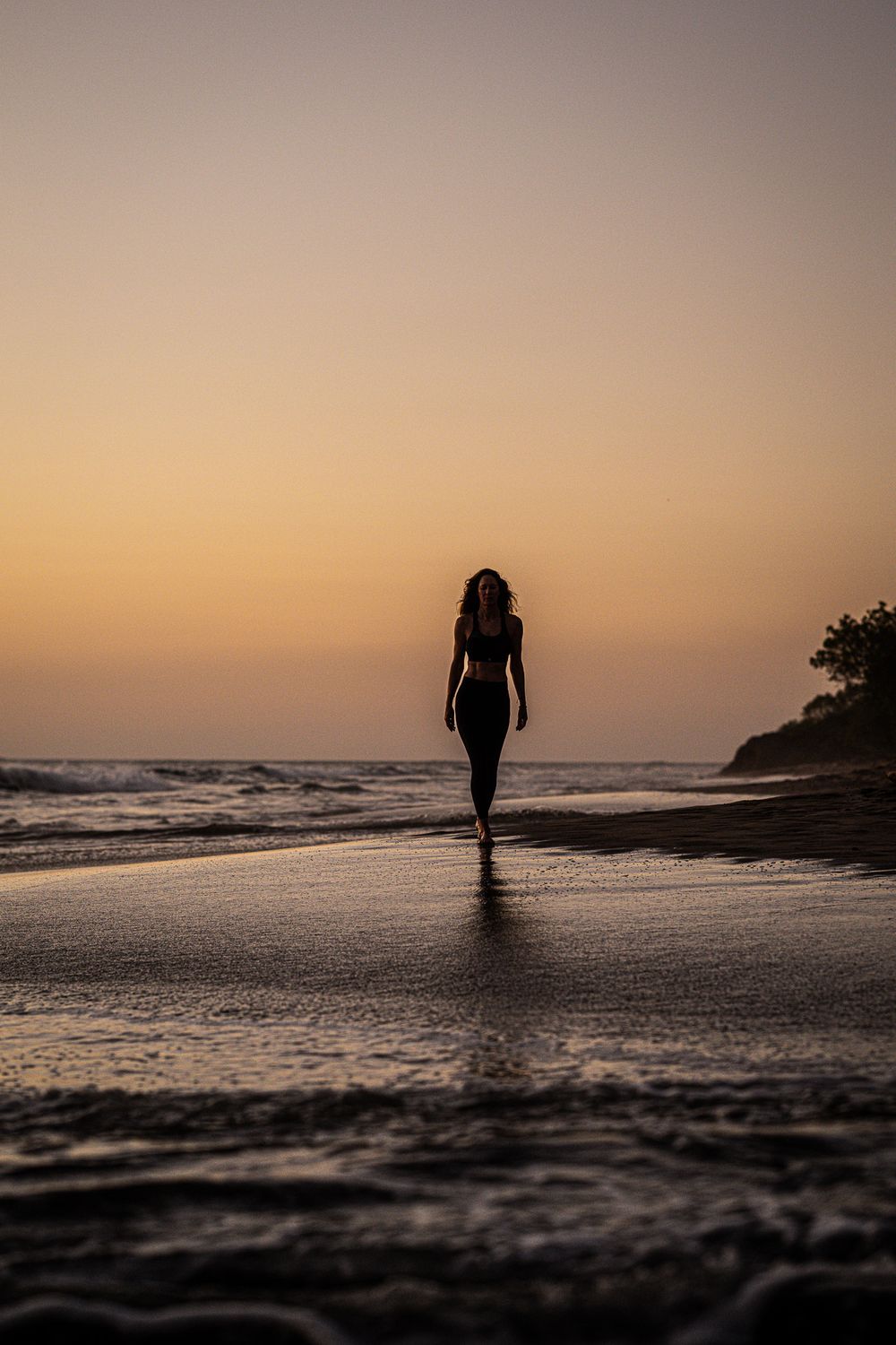 Female yoga student walking at the beach in Playa Negra Costa Rica