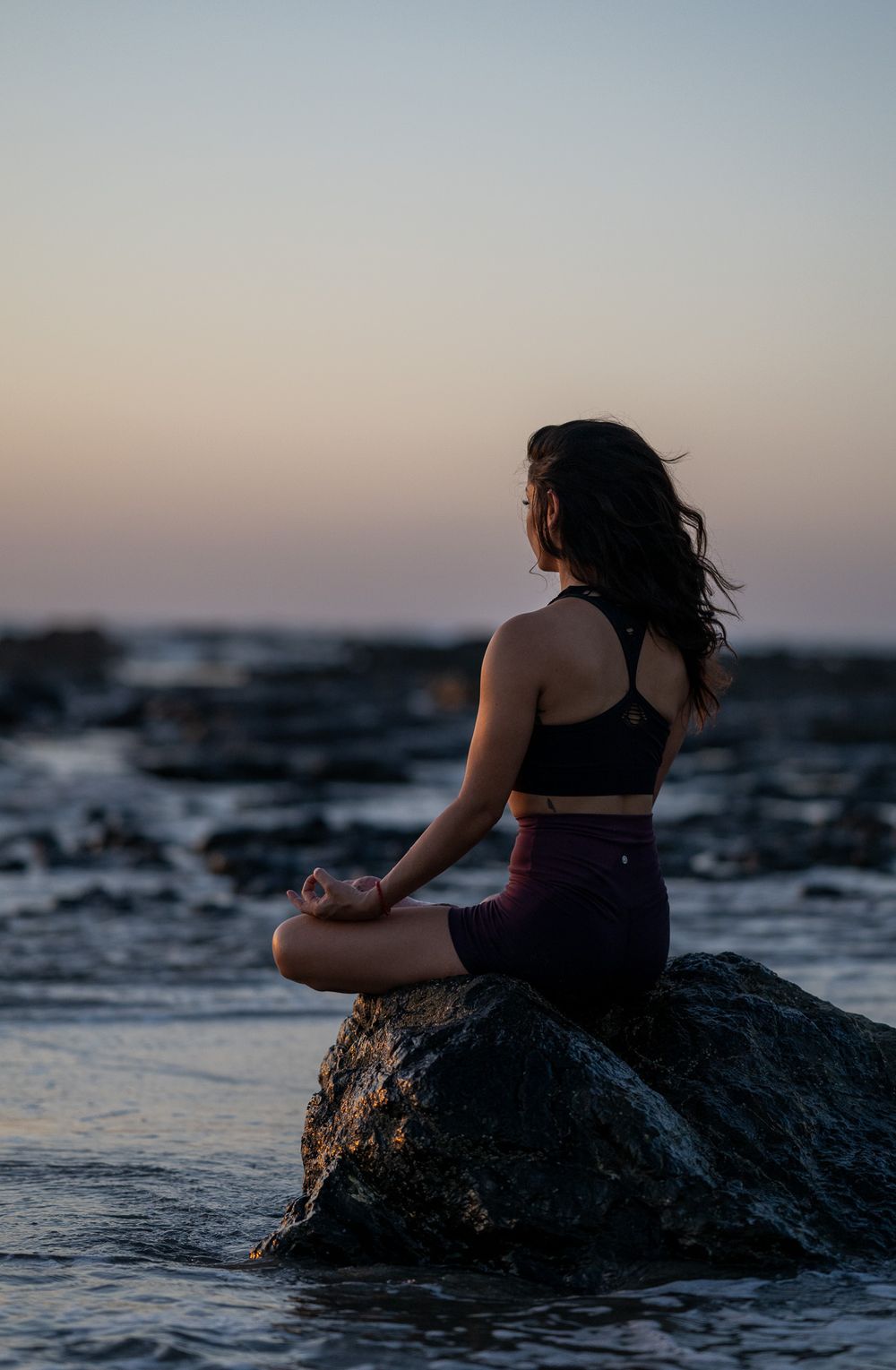 Female yoga student in lotus at the beach in Playa Negra Costa Rica