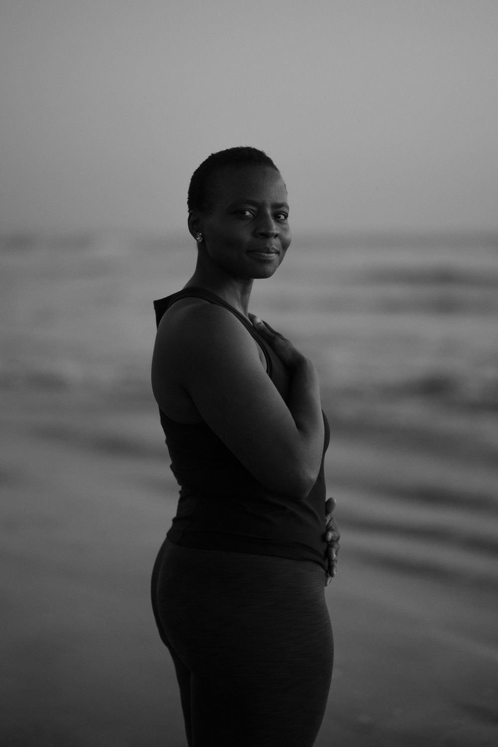 Black and white beachside portrait showing confidence and grace.
