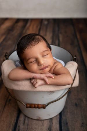 newborn boy in a prop bucket in Sussex County Best Newborn Photographer