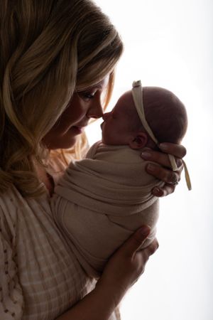 Mother holding her newborn baby in a New Jersey studio