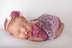 Newborn's delicate eyelashes and button nose, captured in detail in a New Jersey studio