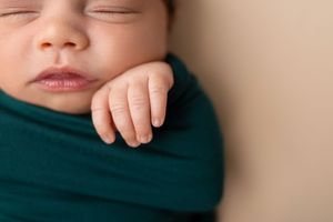 A close-up view of a sleeping baby's face with closed eyes and peaceful expression.