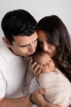 A romantic couple sharing intimate moments in a sequence of four tender poses against a white background.