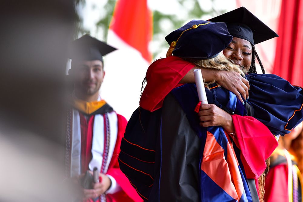 student hugging professor at graduation | HIGHER EDUCATION PHOTOGRAPHER, UNIVERSITY PHOTOGRAPHER