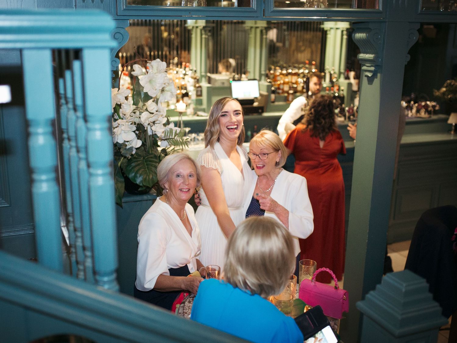 Candid celebration scene with white floral decorations and elegant interior.