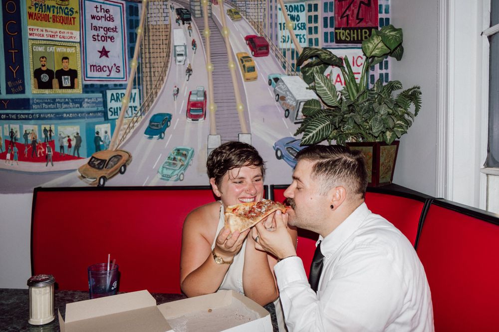 bride and groom eating pizza in virginia beach, virginia