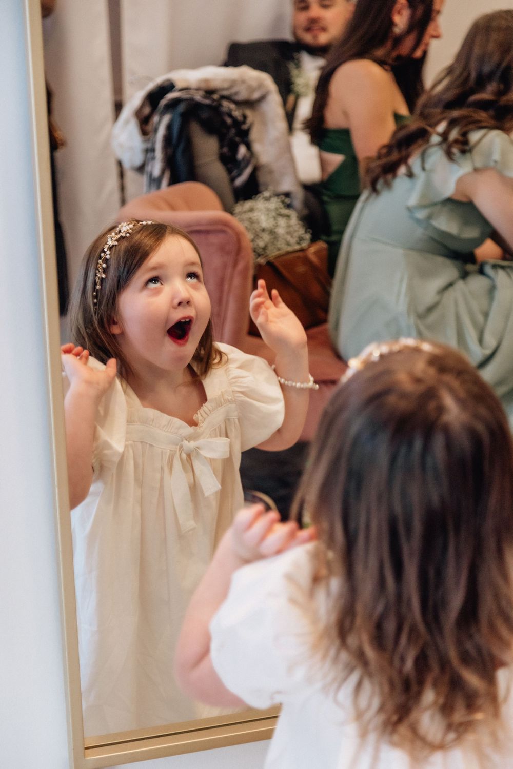 flower girl in newport news, virginia wedding looking into mirror with surprised face