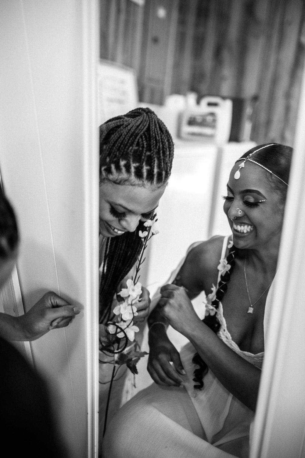 bride and maid of honor getting ready before wedding in norfolk, virginia