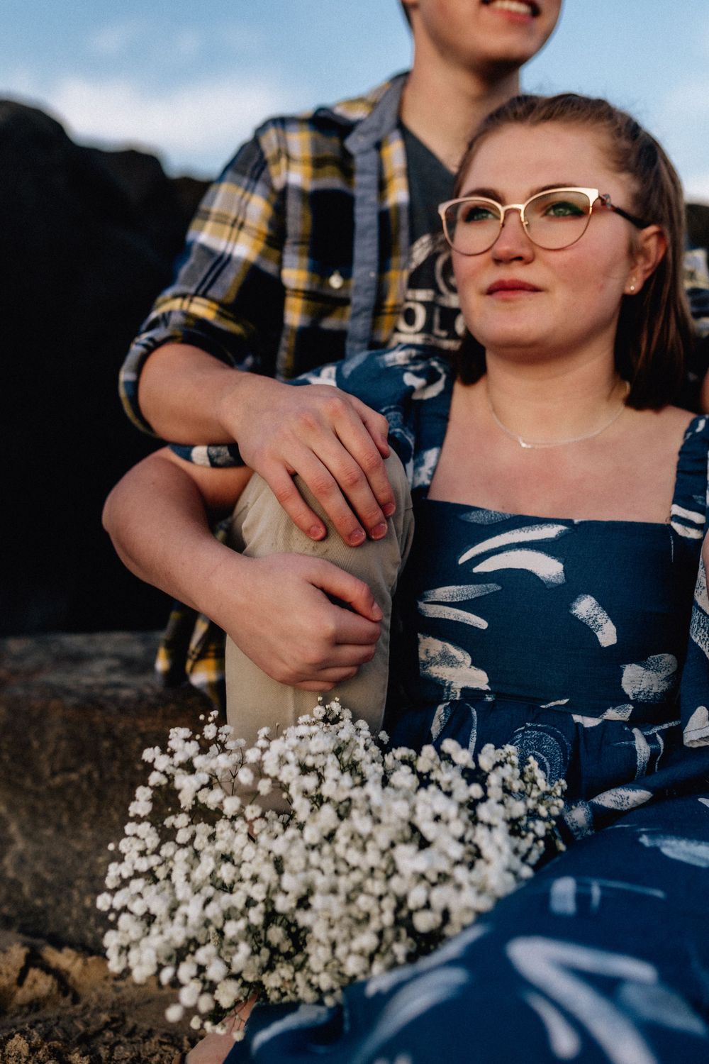 bride and groom sitting on a rock in virginia beach, virginia elopement photography