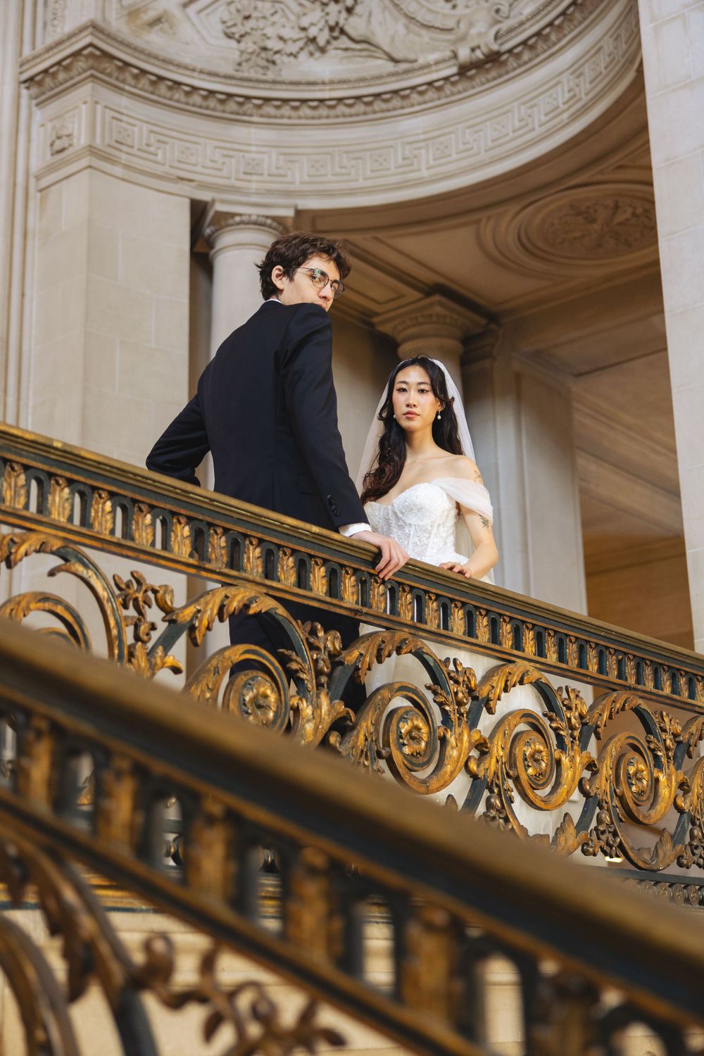 Wedding portrait photograph bride and groom inside San Francisco City Hall, photographed by a Bay Area portrait photographer.