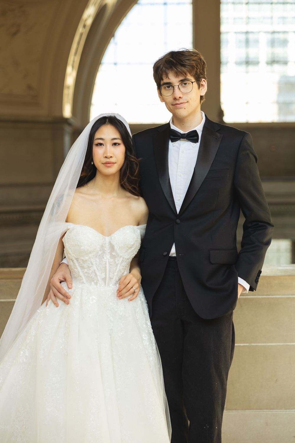 Wedding portrait photograph bride and groom inside San Francisco City Hall, photographed by a Bay Area portrait photographer.