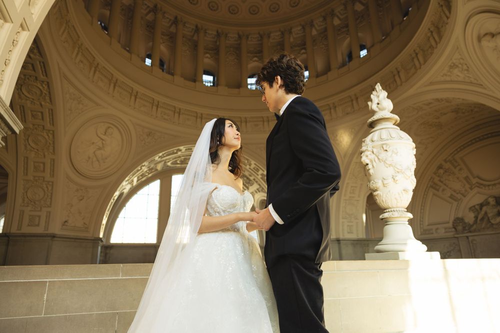 Wedding portrait photograph bride and groom inside San Francisco City Hall, photographed by a Bay Area portrait photographer.
