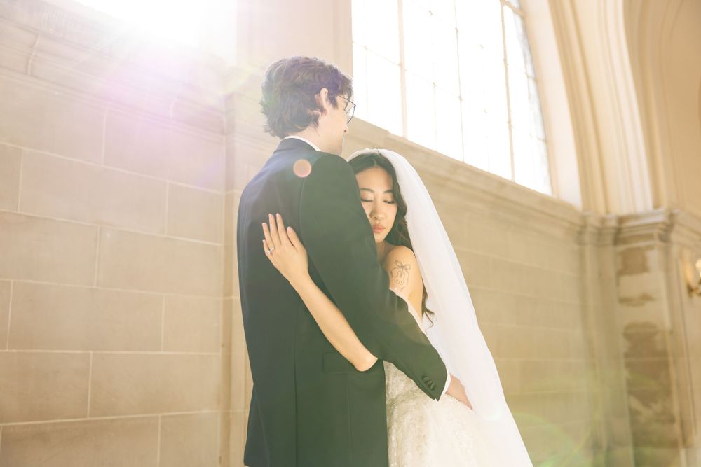 Wedding portrait photograph bride and groom inside San Francisco City Hall, photographed by a Bay Area portrait photographer.