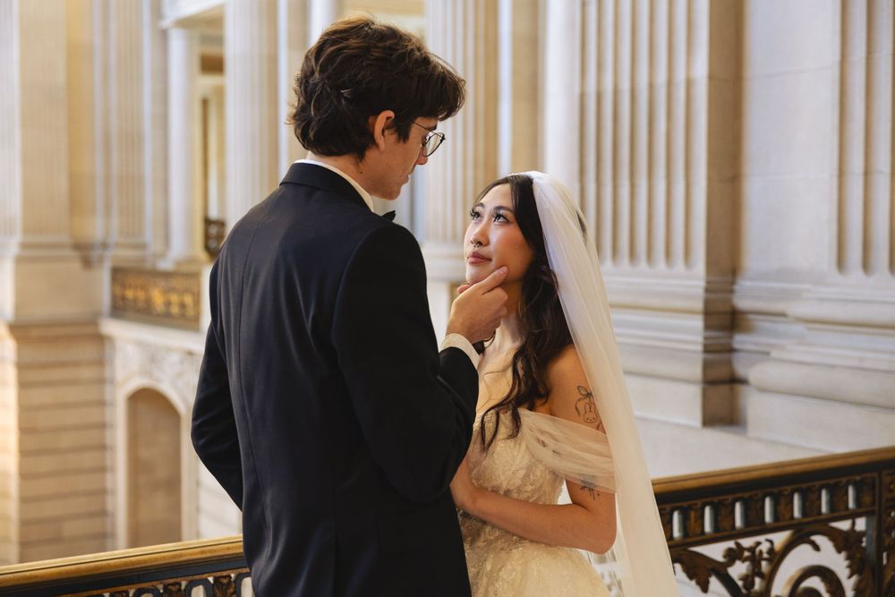 Wedding portrait photograph bride and groom inside San Francisco City Hall, photographed by a Bay Area portrait photographer.