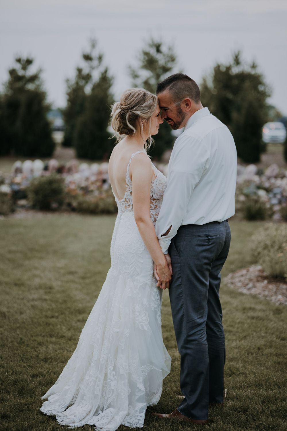 A romantic outdoor wedding photo sequence showing a couple in a grassy field with trees in the background.