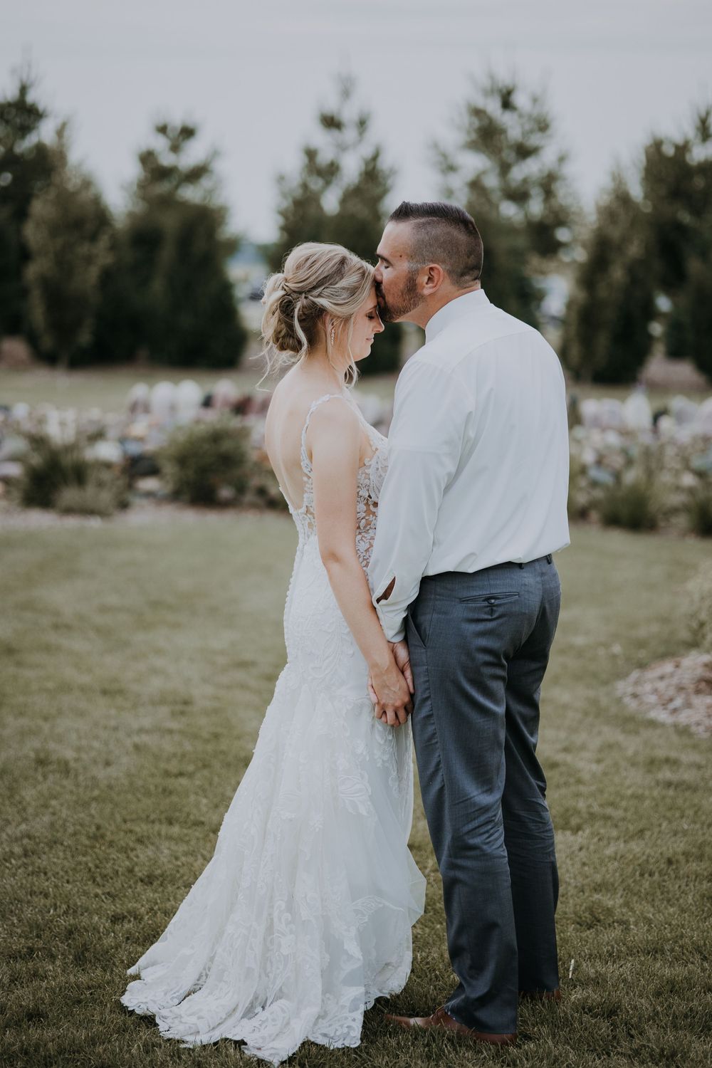 A romantic outdoor wedding photo sequence showing a couple in a grassy field with trees in the background.
