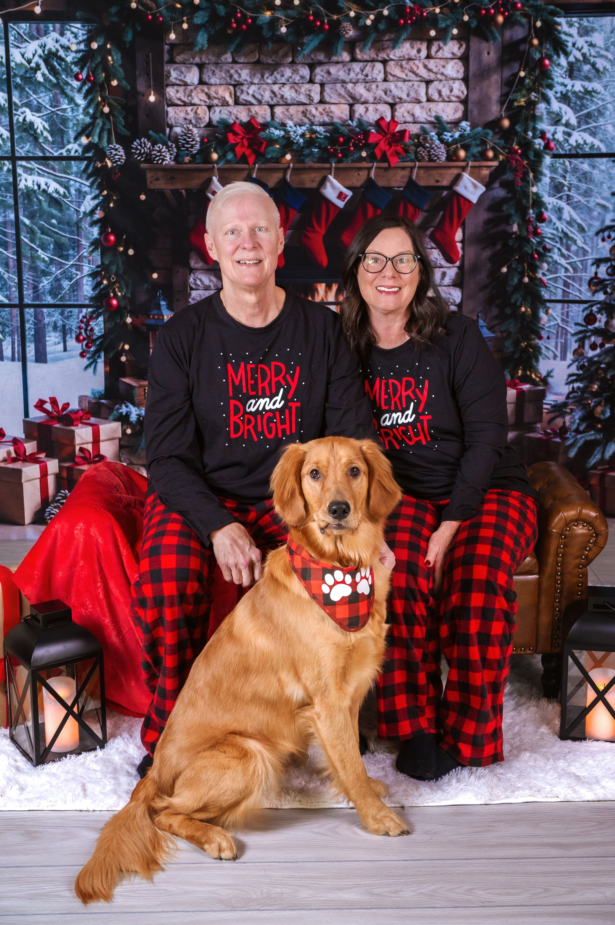 Family Christmas portrait with golden retriever dog in buffalo plaid and festive decor.