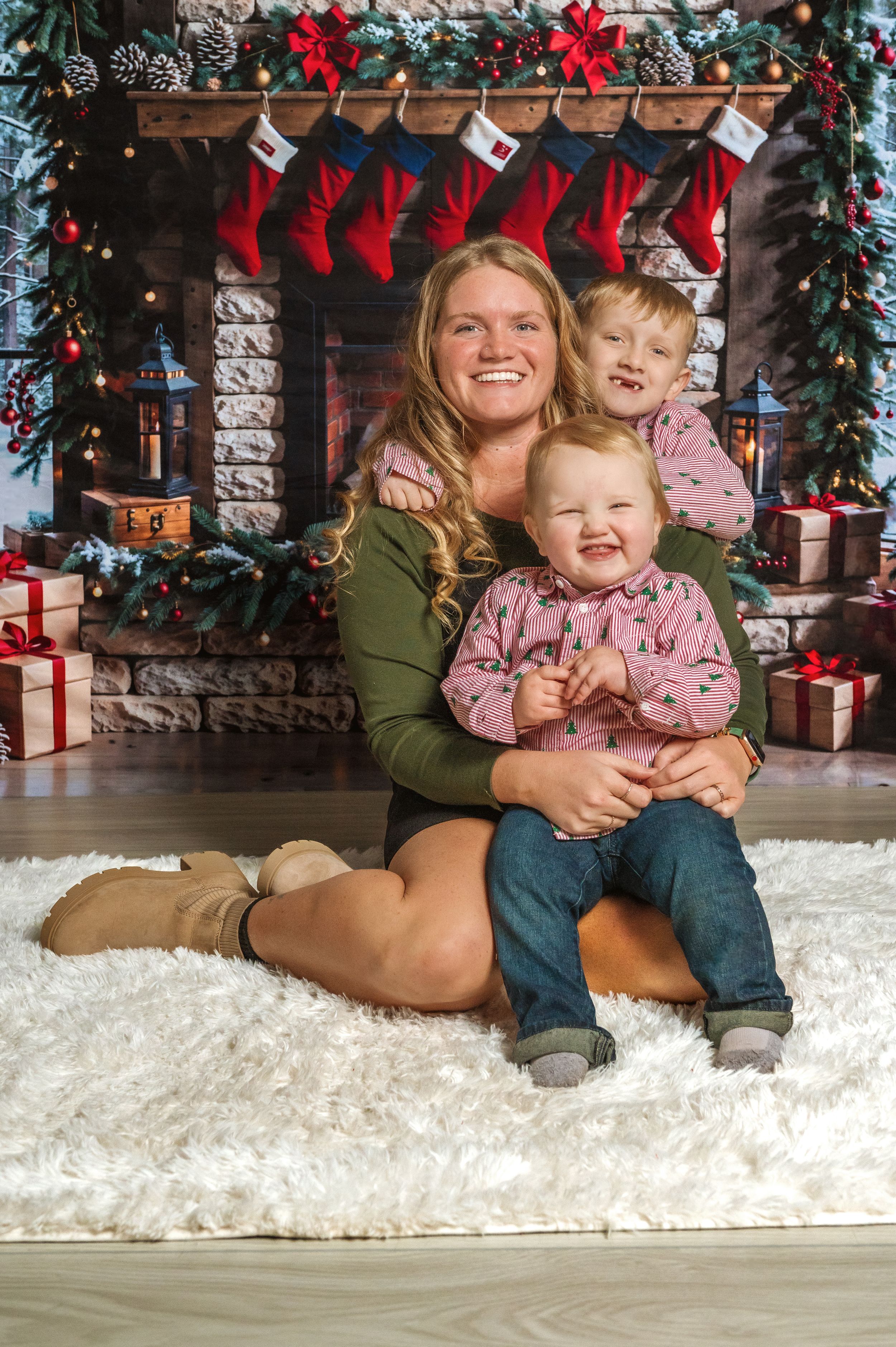Holiday family photos on white faux fur with Christmas decorations and presents in background.