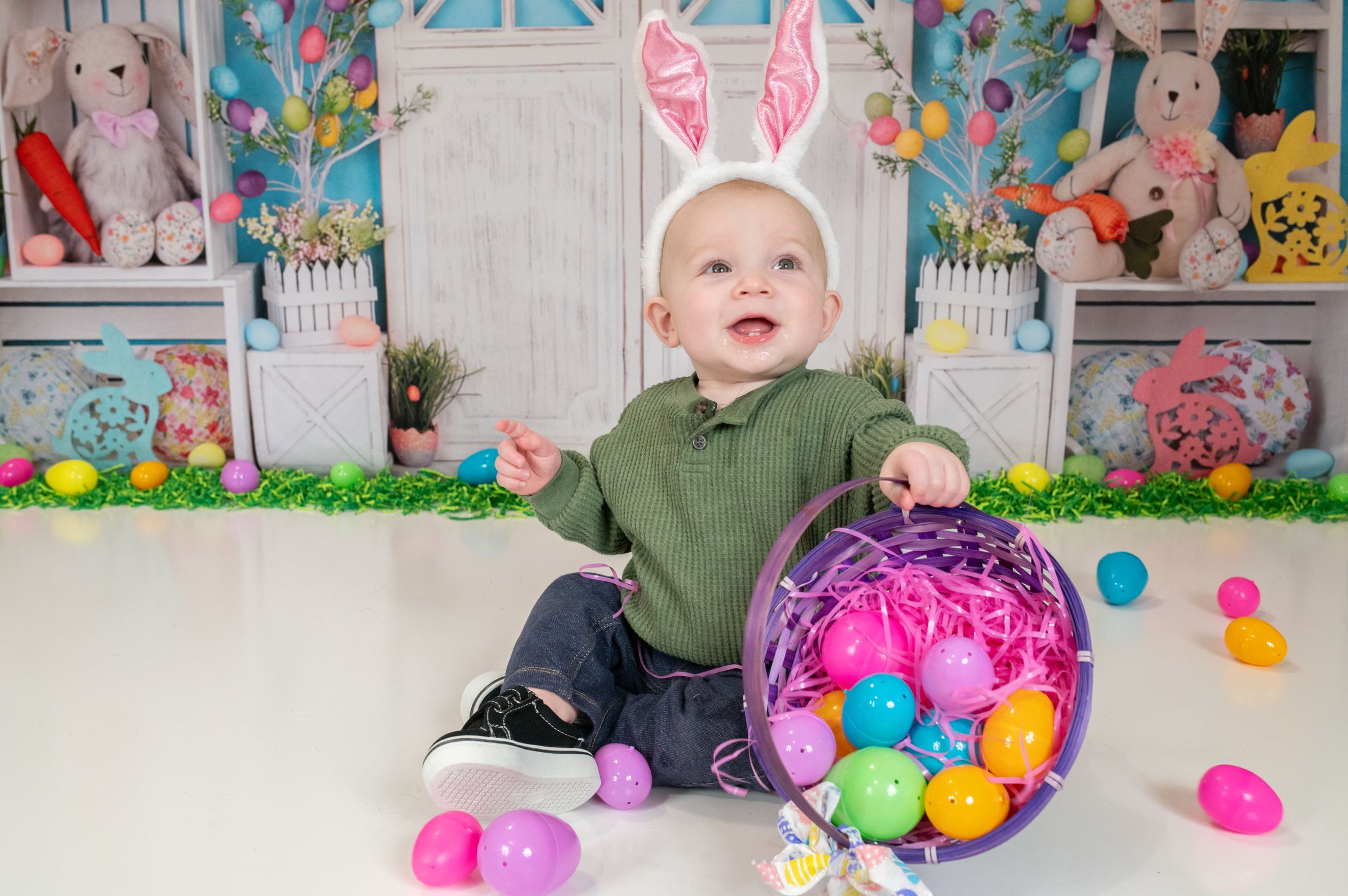 Easter holiday setup with colorful plastic eggs, bunny decorations and festive spring backdrops.