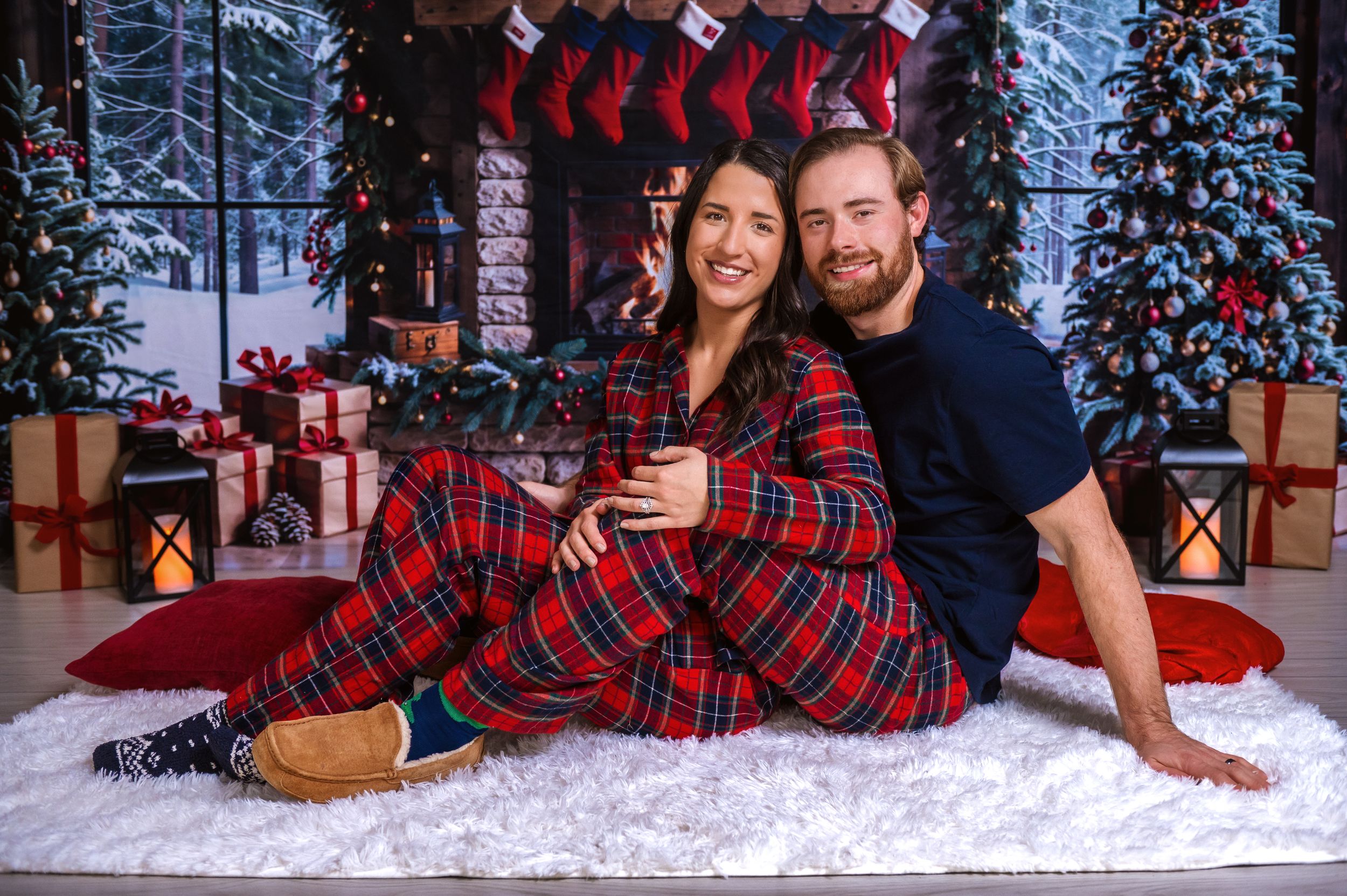 Christmas themed photoshoot with plaid outfits and decorated winter setting.