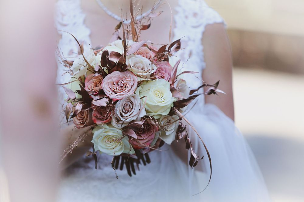 Romantic wedding bouquet with pink and white roses in soft focus.