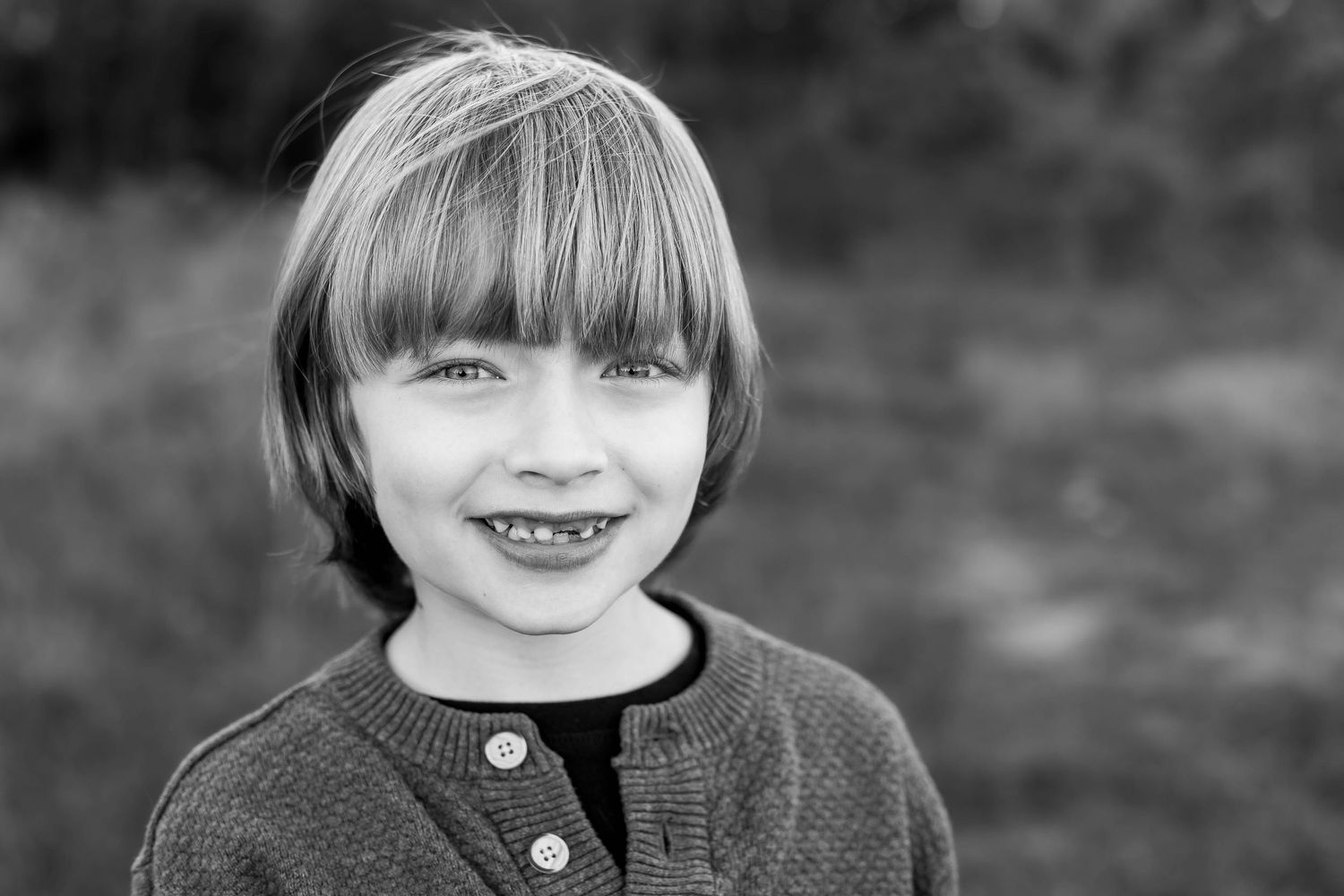 Boy smiling in a field at Southlake Family Photos