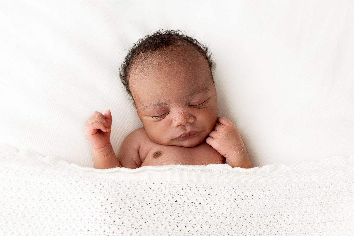 Close up image of Newborn baby feet in a timeless and minimal style